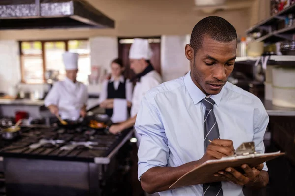 Male Manager Writing Clipboard Kitchen Hotel — Stock Photo, Image