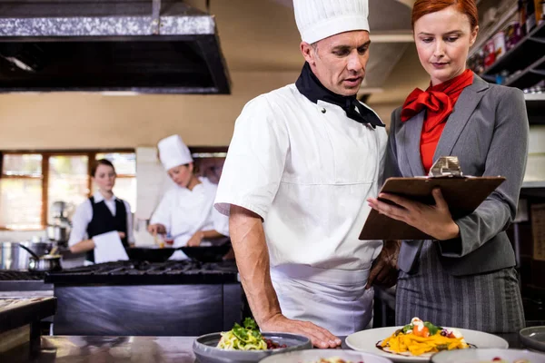 Female Manager Male Chef Writing Clipboard Kitchen Hotel — Stock Photo, Image