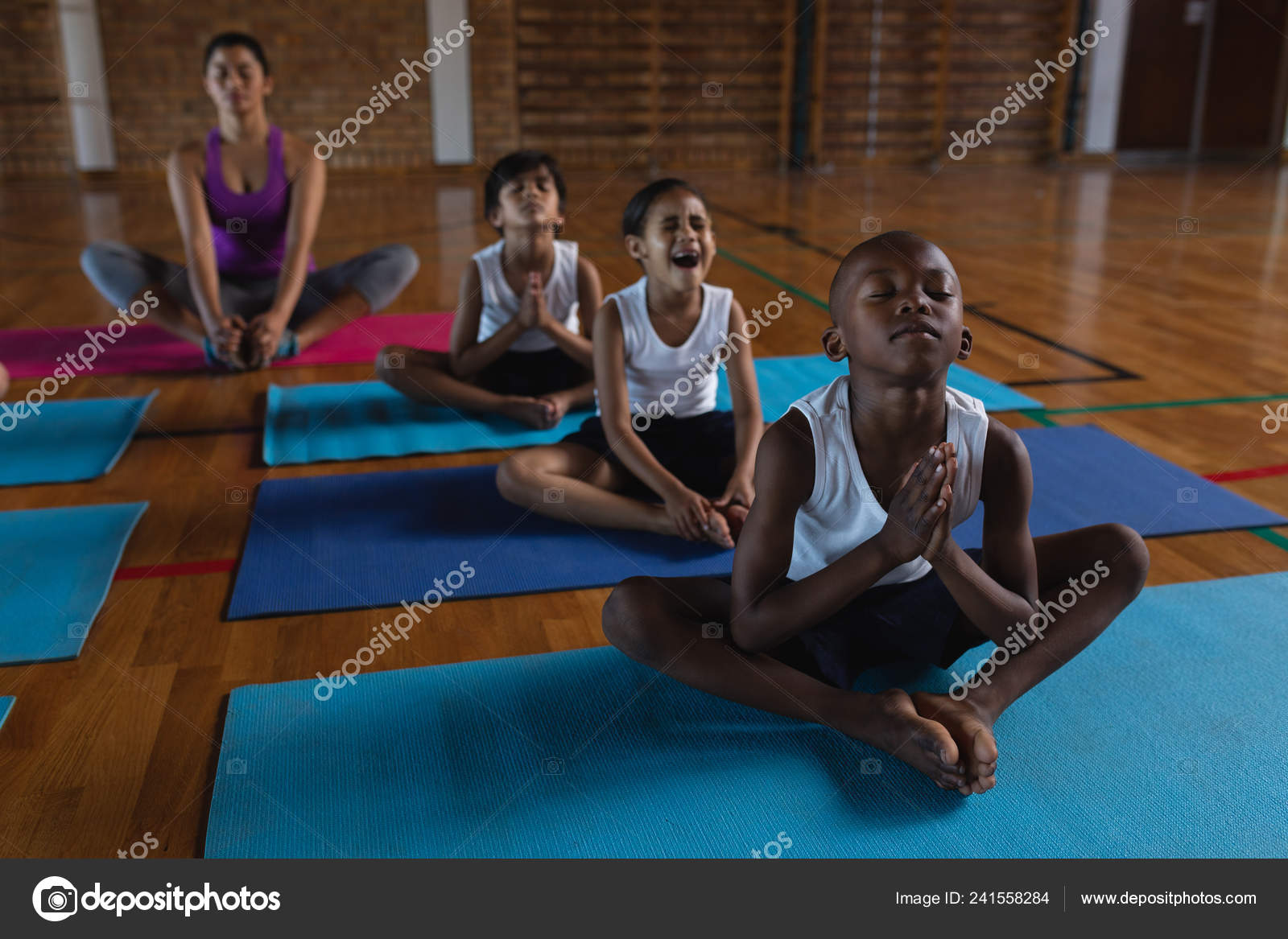 Front View Female Yoga Teacher Schoolkids Doing Yoga Meditating