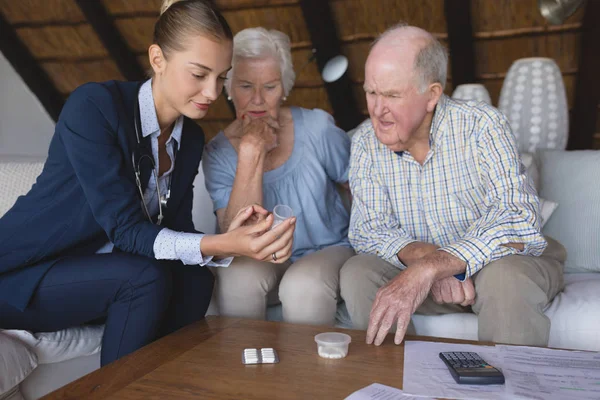 Front View Female Doctor Senior Couple Looking Discussing Medicine Hold — Stock Photo, Image