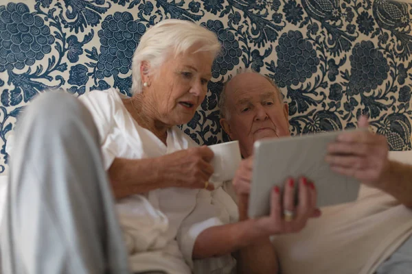 Front View Senior Couple Using Digital Tablet Drinking Bed Home — Stock Photo, Image