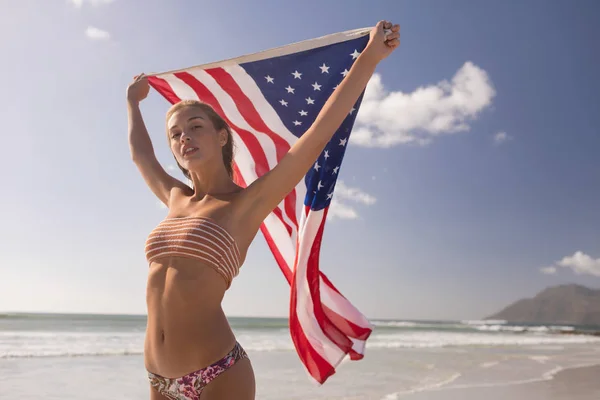 Visão Baixo Ângulo Jovem Segurando Agitando Bandeira Americana Praia Dia — Fotografia de Stock