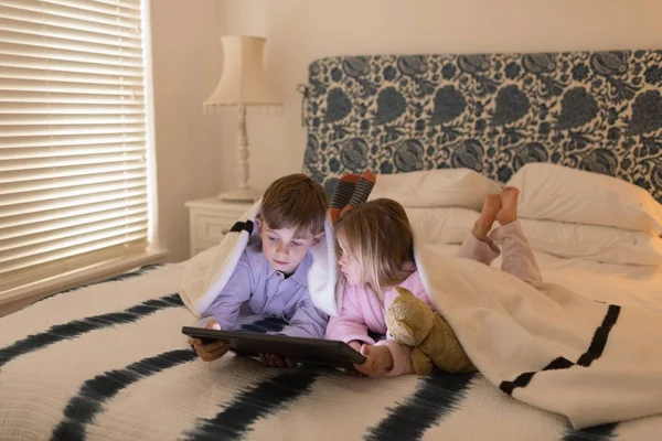 Front View Sweet Brother Sister Using Digital Tablet Blanket Bedroom — Stock Photo, Image