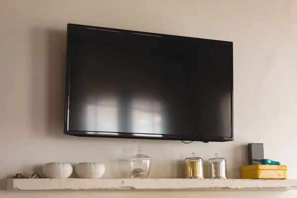 现代电视固定在家里碗和盒子上方的墙上 — 图库照片