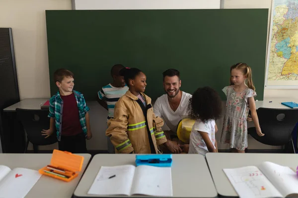 Front View Male Firefighter Teaching Schoolkids Fire Safety Classroom Elementary — Stock Photo, Image