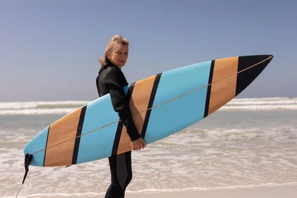 Side View Active Senior Female Surfer Standing Surfboard Beach — Stock Photo, Image