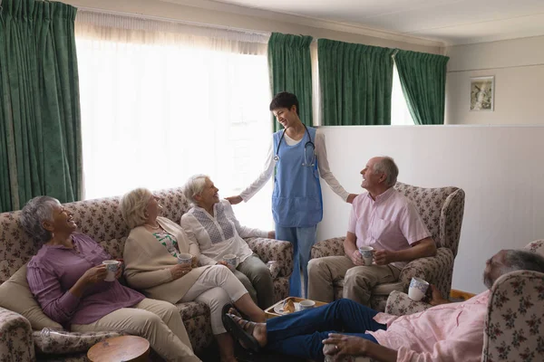 Médecin Femme Interagissant Avec Des Personnes Âgées Dans Salon Maison — Photo