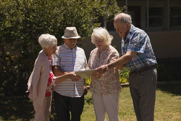 Front View Senior Friends Discussing Digital Tablet Sunny Day Garden — Stock Photo, Image