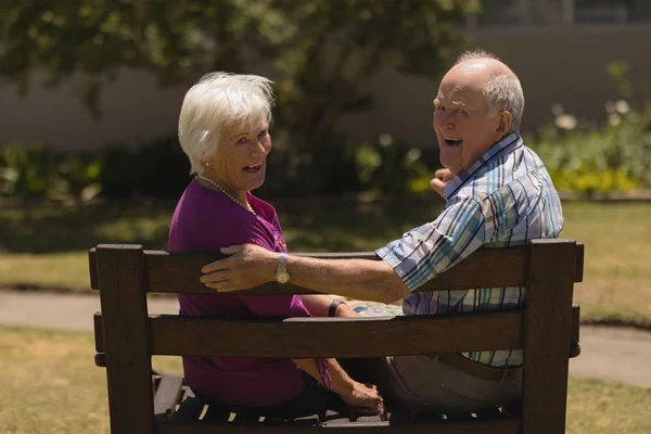 Rear View Active Senior Couple Sitting Together Bench Smiling Camera — Stock Photo, Image