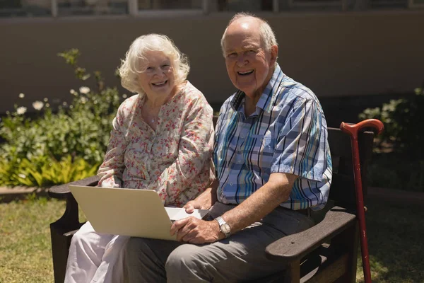 Vista Frontal Casal Sênior Feliz Com Laptop Sentado Banco Olhando — Fotografia de Stock