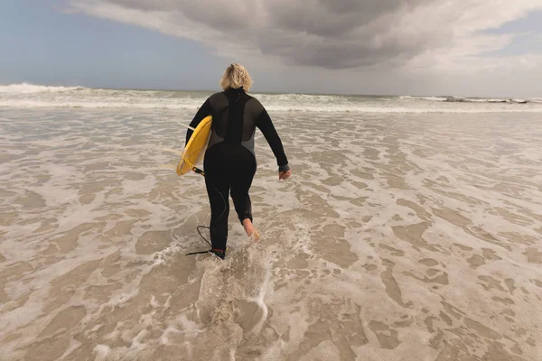 Rear View Senior Woman Running Surfboard Beach — Stock Photo, Image