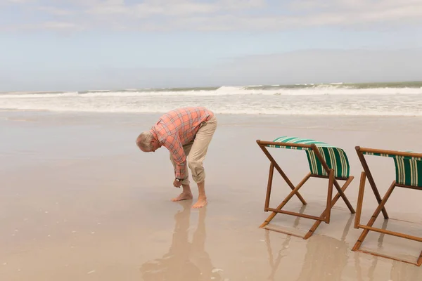 Surface Level Active Senior Man Rolling Trousers Beach Sun Loungers — Stock Photo, Image