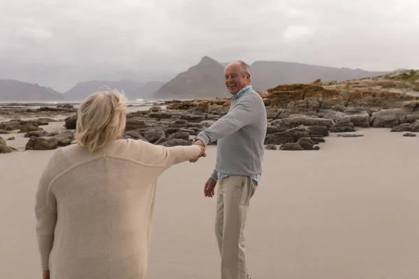 Back View Active Senior Couple Holding Hands Standing Beach Mountains — Stock Photo, Image