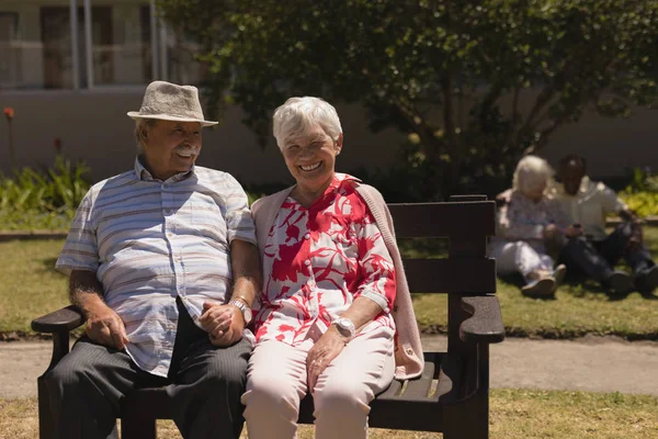 Front View Happy Senior Couple Holding Hands Sitting Bench Garden — Stock Photo, Image