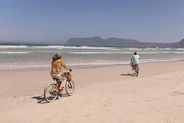 Rear View Senior Couple Riding Bicycle Beach Sunshine Mountains Background — Stock Photo, Image