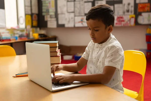 Sidovy Fokuserad Blandad Ras Skolpojke Använder Laptop Vid Bord Ett — Stockfoto