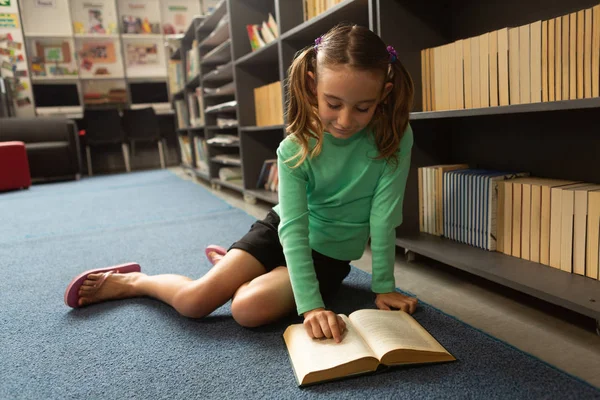 Front View Cute Caucasian Schoolgirl Sitting Floor Reading Book Library — Stock Photo, Image