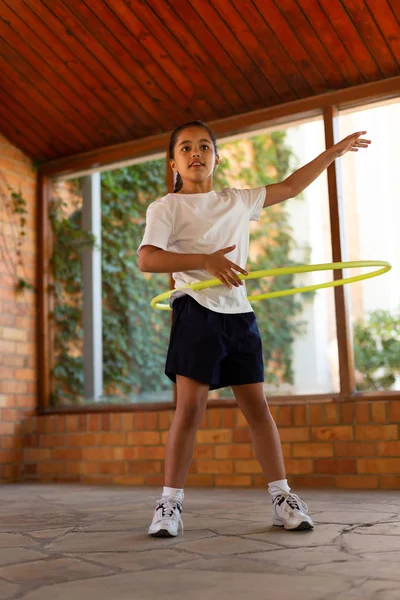 Front View Mixed Race Cute Schoolgirl Spinning Hula Hoop Her — Stock Photo, Image