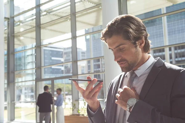 Side View Young Caucasian Businessman Talking Mobile Phone Lobby Office — Stock Photo, Image