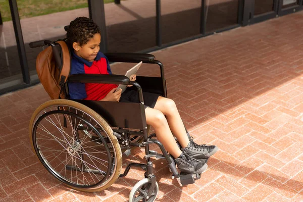 Side View Smiling Mixed Raced Disabled Schoolboy Using Digital Tablet — Stock Photo, Image