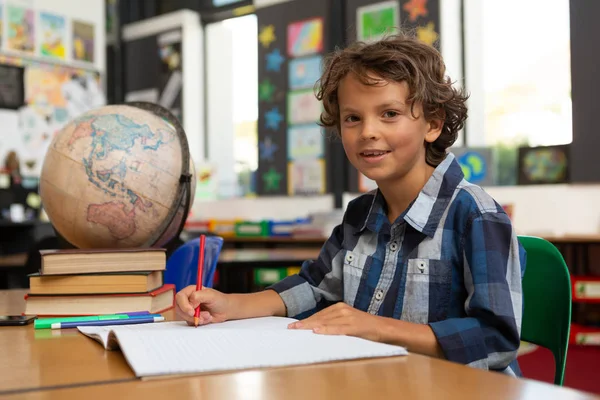 Side View Caucasian Schoolboy Studying Desk While Looking Camera Classroom — Stock Photo, Image