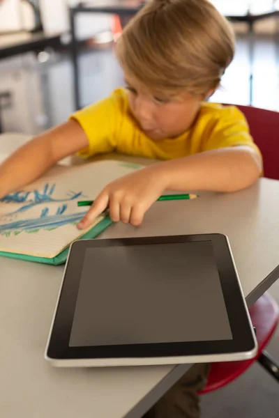 Front View Cute Caucasian Boy Drawing Sketch Notebook Desk Classroom — Stock Photo, Image