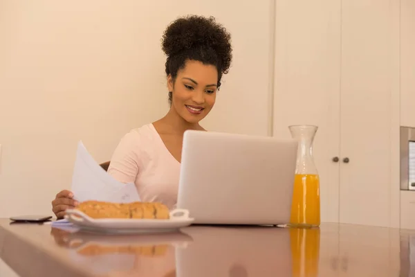 家でノート パソコンを使用している間フォームを見てアフリカ系アメリカ人の美しい女性の正面図 — ストック写真