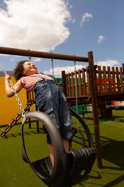 Side View Mixed Race Schoolboy Playing Swing School Playground Sunny — Stock Photo, Image