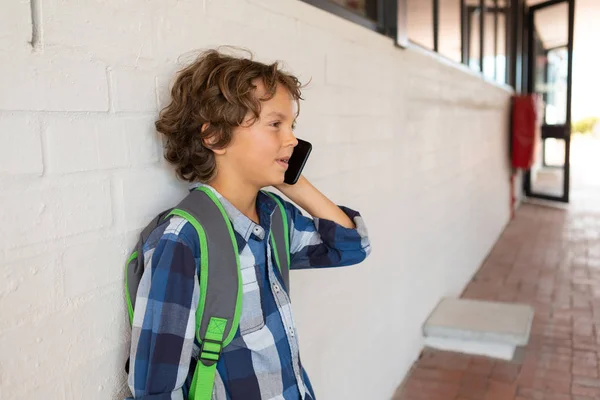 Side View Caucasian Schoolboy Talking Mobile Phone While Leaning Wall — Stock Photo, Image