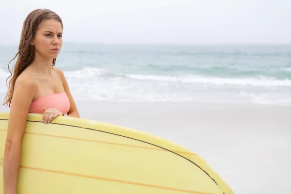 Onu Sörf Tahtası Sahilde Tutan Genç Kadın Düşük Bölümü Düşünüyor — Stok fotoğraf