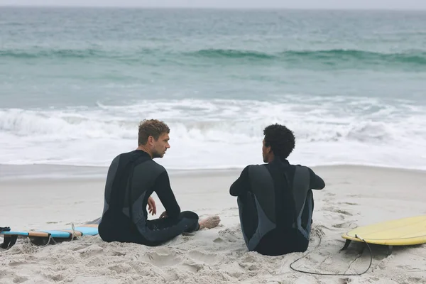 Вид Сзади Молодых Многонациональных Друзей Мужчин Сидящих Пляже Взаимодействуя Друг — стоковое фото