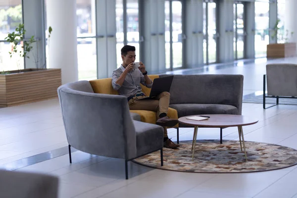 Side View Young Asian Male Executive Having Coffee While Using — Stock Photo, Image