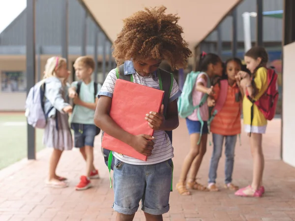 Front View African Ethnicity Schoolboy Holding Red Book Arms While — Stock Photo, Image