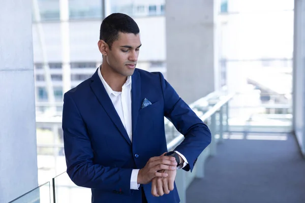 Front View Handsome Young Mixed Race Businessman Using Smartwatch Standing — Stock Photo, Image