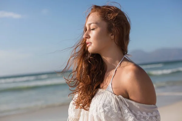 站在海滩上的白种人妇女闭着眼睛的侧视图 她看起来很放松 — 图库照片