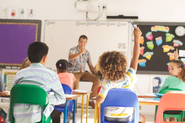 Rear View School Kids Raising Hand While Teacher Asking Question — Stock Photo, Image