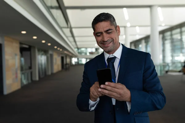 Front View Businessman Laughing Using His Mobile Phone Office Lobby — Stock Photo, Image