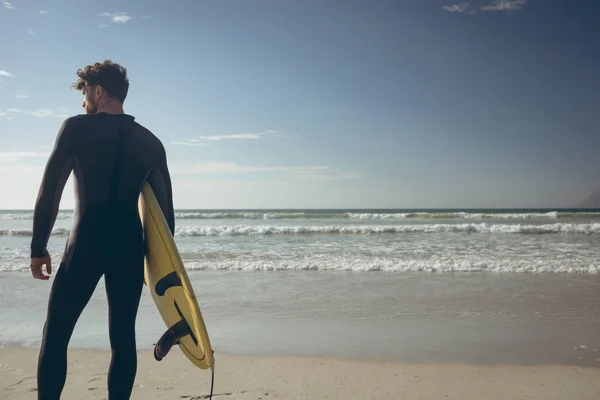 Rear View Young Caucasian Male Surfer Surfboard Standing Beach Sunny — Stock Photo, Image