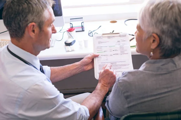 Front View Matured Caucasian Male Doctor Showing Medical Report Senior — Stock Photo, Image