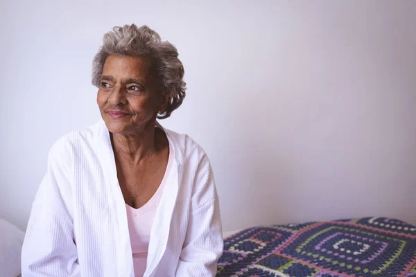 Вид Спереди Вдумчивой Старшей Расовой Женщины Улыбающейся Глядя Окно Дома — стоковое фото
