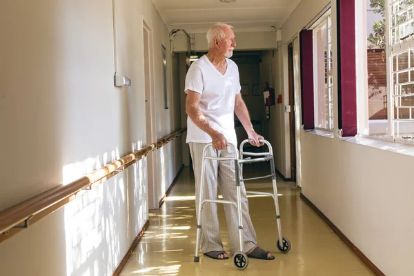 Side View Senior Caucasian Male Patient Standing Walker Corridor Retirement — Stock Photo, Image