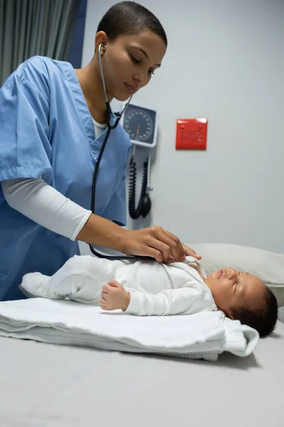 Front View Mixed Race Female Doctor Examining Baby Stethoscope Table — 图库照片