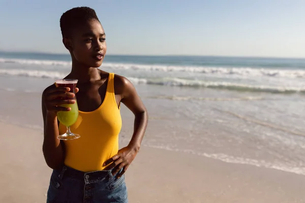 Front View Thoughtful African American Woman Cocktail Drink Standing Beach — Stock Photo, Image