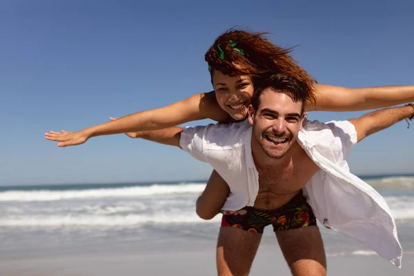 Front View Happy Mixed Race Man Giving Piggyback Woman Beach — Stock Photo, Image