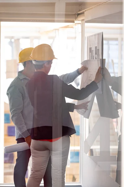 Side View Caucasian Architects Discussing Blueprint Glass Board Modern Office — Stock Photo, Image