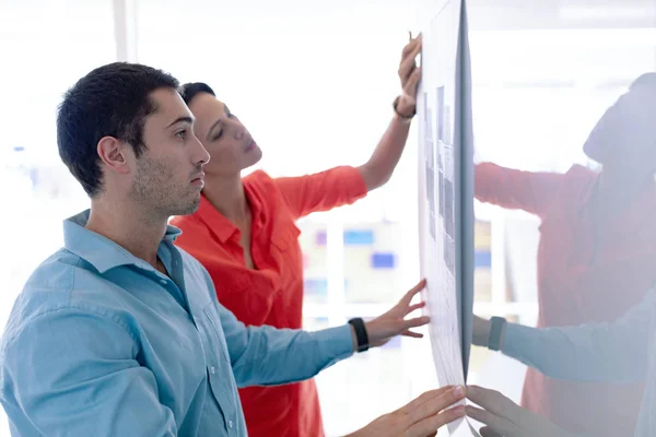 Side View Caucasian Architects Discussing Blueprint Glass Board Modern Office — Stock Photo, Image
