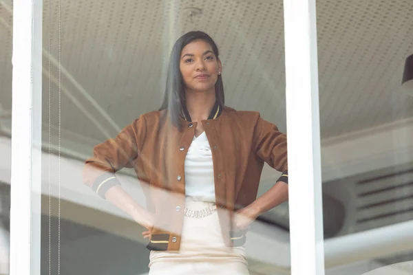 Front View Happy Mixed Race Businesswoman Hands Hips Standing Window — Stok fotoğraf