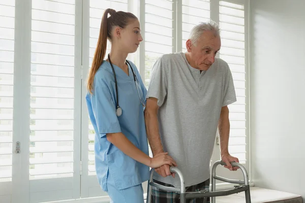 Side View Caucasian Female Doctor Helping Active Senior Man Walk — Stock Photo, Image