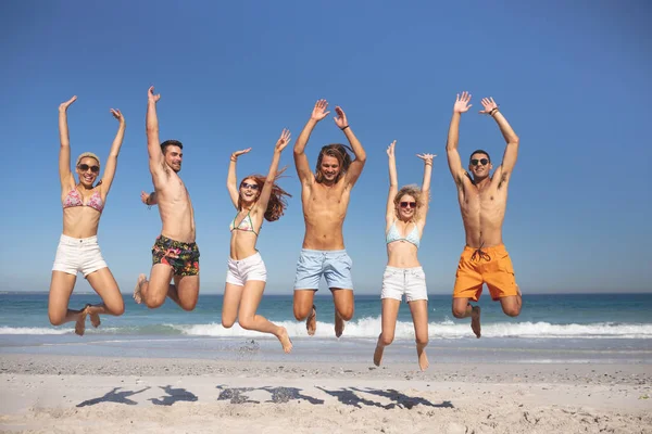 Front View Group Young Diverse Friends Jumping Together Beach — Stock Photo, Image
