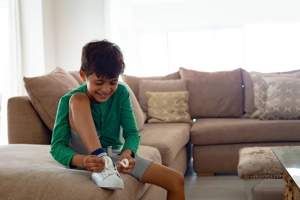 Front View Happy American Boy Tying Shoelace Sofa Living Room — Stock Photo, Image